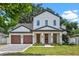 Charming two-story home featuring a well-manicured lawn and black framed windows at 1780 Mizell Ave., Winter Park, FL 32789