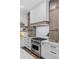 Close up of the stainless steel stove and range hood of the updated kitchen at 1780 Mizell Ave., Winter Park, FL 32789