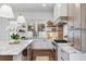 Contemporary kitchen featuring custom cabinetry, marble countertops, stainless steel appliances, and modern lighting at 1780 Mizell Ave., Winter Park, FL 32789