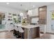 Bright kitchen with marble countertops, custom cabinetry, modern fixtures, and barstool seating at the island at 1780 Mizell Ave., Winter Park, FL 32789