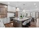Open concept kitchen with dining area, stainless steel appliances, custom countertops, and island with barstool seating at 1780 Mizell Ave., Winter Park, FL 32789