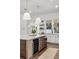 Updated kitchen featuring a large island, stainless steel appliances, custom cabinetry, and modern pendant lighting at 1780 Mizell Ave., Winter Park, FL 32789