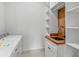 Well-organized laundry area with a modern sink, butcher block countertop, white shelving and a washing machine at 1780 Mizell Ave., Winter Park, FL 32789