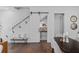 Living room with glass-enclosed staircase, sliding pantry door, and modern decor at 1780 Mizell Ave., Winter Park, FL 32789