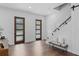 Bright foyer with dark wood doors and a glass-enclosed staircase at 1780 Mizell Ave., Winter Park, FL 32789