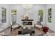 Bright living room featuring a modern fireplace, stylish decor, and lots of natural light at 1780 Mizell Ave., Winter Park, FL 32789