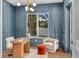 Stylish office with custom blue wall trim, light wood floors, and large bright window at 1780 Mizell Ave., Winter Park, FL 32789