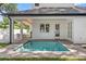 Inviting backyard pool with brick pavers, covered patio and well-manicured lawn at 1780 Mizell Ave., Winter Park, FL 32789