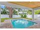 Backyard pool and covered patio offer an ideal space for relaxation at 1780 Mizell Ave., Winter Park, FL 32789