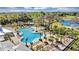 Aerial view showcasing a resort-style community pool, lush landscaping, and recreational amenities at 1853 Fulfillment Dr, Kissimmee, FL 34744