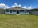 Well-maintained backyard with a lush lawn and a view of the home's rear exterior at 1950 Birnham Wood Bnd, Kissimmee, FL 34746