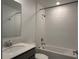 Well-lit bathroom features a shower-tub combo with white tiles, a sleek vanity, and a stylish mirror at 1950 Birnham Wood Bnd, Kissimmee, FL 34746