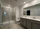 Bathroom showcasing double vanity, tiled floors, and glass-enclosed shower at 1950 Birnham Wood Bnd, Kissimmee, FL 34746