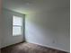 Bright bedroom with plush carpeting and a window, offering a comfortable and relaxing space at 1950 Birnham Wood Bnd, Kissimmee, FL 34746