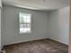 Bright bedroom with plush carpeting and a window, offering a comfortable and relaxing space at 1950 Birnham Wood Bnd, Kissimmee, FL 34746