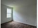 Cozy bedroom with plush carpeting and a window, offering a comfortable and relaxing space at 1950 Birnham Wood Bnd, Kissimmee, FL 34746