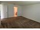 This bedroom features neutral walls and carpet, with a bathroom adjacent at 1950 Birnham Wood Bnd, Kissimmee, FL 34746