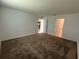 This bedroom features neutral walls and carpet, with two doors leading to the bathroom and kitchen at 1950 Birnham Wood Bnd, Kissimmee, FL 34746