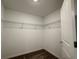 Walk-in closet with wire shelving and carpeted floor provides ample storage space at 1950 Birnham Wood Bnd, Kissimmee, FL 34746