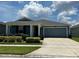 Charming single-story home with lush landscaping and a well-maintained front yard at 1950 Birnham Wood Bnd, Kissimmee, FL 34746