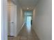 Bright hallway with tile flooring leads to a living area with sliding glass doors, providing a seamless transition at 1950 Birnham Wood Bnd, Kissimmee, FL 34746