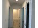 Bright hallway with multiple doorways to other rooms and tiled flooring at 1950 Birnham Wood Bnd, Kissimmee, FL 34746
