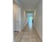 The long hallway features tiled floors, and ends in a bright living space at 1950 Birnham Wood Bnd, Kissimmee, FL 34746