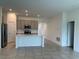 Open-concept kitchen and dining area with stainless steel appliances and modern cabinetry at 1950 Birnham Wood Bnd, Kissimmee, FL 34746