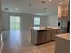 Modern kitchen with stainless steel appliances, quartz countertops, and an island with a built-in dishwasher at 1950 Birnham Wood Bnd, Kissimmee, FL 34746