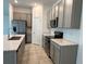 Well-equipped kitchen featuring stainless steel appliances, stylish cabinetry, and a white subway tile backsplash at 1950 Birnham Wood Bnd, Kissimmee, FL 34746
