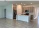 Open-concept kitchen with modern appliances and a kitchen island, flowing into the dining and living areas at 1950 Birnham Wood Bnd, Kissimmee, FL 34746