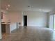 Bright open-concept living area with tile flooring, high ceilings and a seamless transition to the kitchen at 1950 Birnham Wood Bnd, Kissimmee, FL 34746