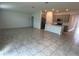 Spacious open-concept living area with tile flooring and seamless transition to the modern kitchen at 1950 Birnham Wood Bnd, Kissimmee, FL 34746
