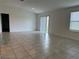 Bright and spacious living room featuring tile flooring, a sliding glass door and plenty of natural light at 1950 Birnham Wood Bnd, Kissimmee, FL 34746