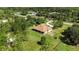 Aerial shot of property featuring lush lawn, a house with a light-colored exterior, and mature landscaping at 19606 Reynolds Pkwy, Orlando, FL 32833