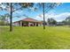 Spacious backyard with lush grass, covered patio, and a view of neighboring properties at 19606 Reynolds Pkwy, Orlando, FL 32833