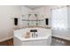 A bathtub offers a corner design with tiled surround and decorative accents for relaxation and style at 19606 Reynolds Pkwy, Orlando, FL 32833