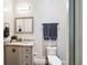 Well-maintained bathroom with a stylish vanity, a mirror, and a toilet at 19606 Reynolds Pkwy, Orlando, FL 32833