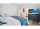 Comfortable bedroom features a large dresser, a TV, and easy access to an en-suite bathroom at 19606 Reynolds Pkwy, Orlando, FL 32833