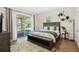 Modern bedroom with sliding glass doors leading to a patio and lush backyard views at 19606 Reynolds Pkwy, Orlando, FL 32833