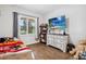 Well-lit bedroom featuring a cozy bed, a dresser, and a window overlooking the outdoor scenery at 19606 Reynolds Pkwy, Orlando, FL 32833