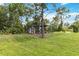 Chicken coop and pen in a grassy backyard, perfect for hobby farming at 19606 Reynolds Pkwy, Orlando, FL 32833