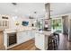 Elegant kitchen features an island, wine fridge, stainless appliances, and plenty of counter space at 19606 Reynolds Pkwy, Orlando, FL 32833
