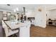Bright kitchen featuring white cabinets, stainless steel appliances, a large island with granite counter tops, and hardwood floors at 19606 Reynolds Pkwy, Orlando, FL 32833