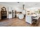 Modern kitchen featuring white cabinets, stainless steel appliances, a large island and hardwood floors at 19606 Reynolds Pkwy, Orlando, FL 32833