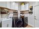 Well-organized laundry room with modern washer and dryer, ample storage, and a utility sink at 19606 Reynolds Pkwy, Orlando, FL 32833