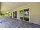 The covered patio features brick pavers and sliding glass doors that offer seamless indoor-outdoor living at 19606 Reynolds Pkwy, Orlando, FL 32833