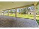 A covered patio offers outdoor views of the lush, green lawn and outbuildings on the property at 19606 Reynolds Pkwy, Orlando, FL 32833