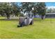 Outdoor well system and filtration equipment enclosed by a wooden fence in a grassy yard at 19606 Reynolds Pkwy, Orlando, FL 32833