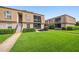 Exterior view of condo buildings with well-maintained lawns and mature landscaping at 200 St Andrews Blvd # 601, Winter Park, FL 32792